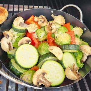 A grill pan full of smoked veggies